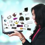 Lady holding laptop with multiple items visually coming out of it